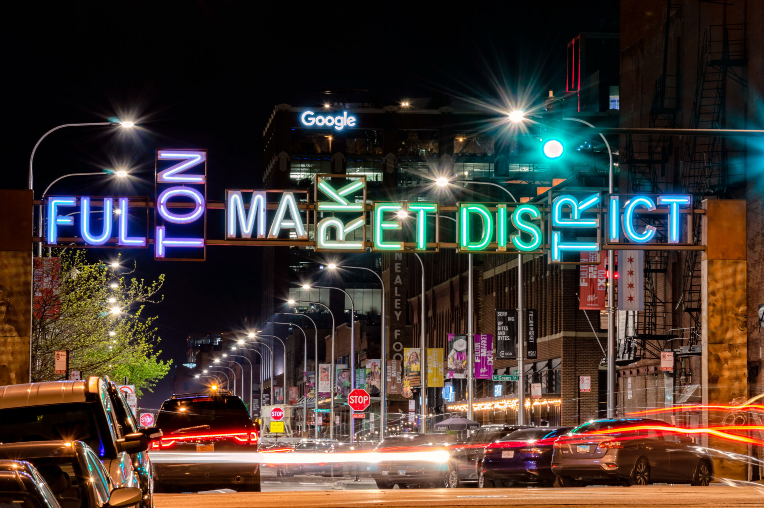 Fulton Market, Chicago-May 13, 2019: Fulton Maket District gateway at night with neon lights and light trails. Main street in Chicago, Illinois.